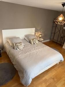 a bedroom with a white bed with pillows on it at Appartement centre ville in Langres