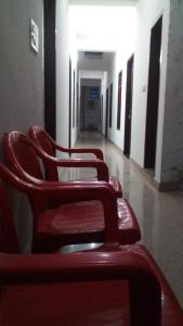 a row of red seats in a hallway at Radha Rani Dham in Rādha Kund