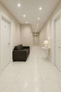 a living room with a black couch and a table at Modern Luxury Rooms in Hillingdon