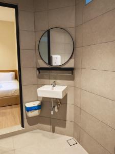 a bathroom with a sink and a mirror at Mutiara Gurney at 15, Lorong Kelawai in George Town +68 photos
