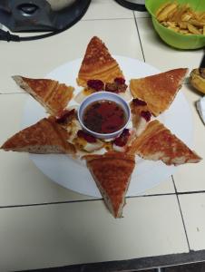 a plate of tortilla chips with a bowl of dipping sauce at TiKi Hostel Island Ometepe in Rivas