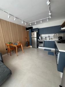 a kitchen with a table and a dining room at Refúgio da Lagoa azul in Angra dos Reis +26 photos