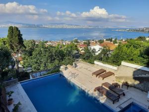 a swimming pool with a view of the water at Manzaraada Tepe in Heybeliada