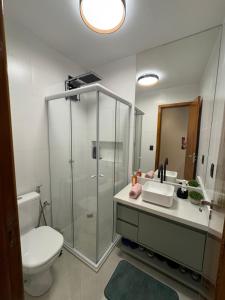 a bathroom with a shower and a toilet and a sink at Refúgio da Lagoa azul in Angra dos Reis