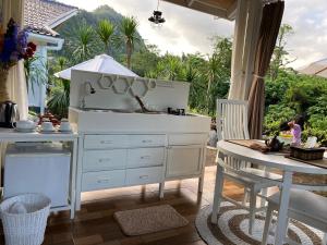 a kitchen with a white dresser and a table at The River Island Sidemen in Sidemen