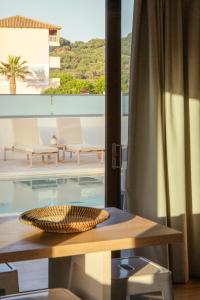 a room with a table and a view of a pool at Peratzada in Tsilivi