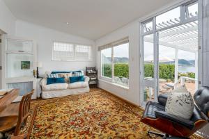a living room with a couch and a table at Spectacular views Simonstown in Cape Town