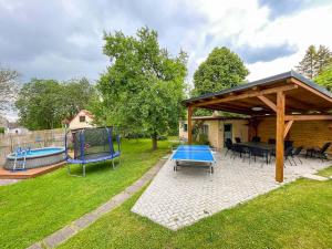 a backyard with a picnic table and a playground at Chalupa u Hejsků in Jilem