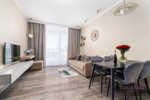 a living room with a couch and a table at Your Holidays Bel Mare Aqua E504 in Międzyzdroje