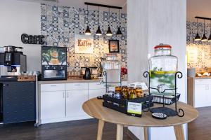 a kitchen with a table with a jar of food at Garner Hotel Cologne Porz - Airport by IHG in Cologne