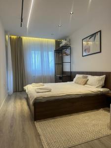 a bedroom with a large bed in a room at Aparte - Emshir in Pristina +18 photos