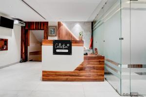 a lobby with a staircase with a sign on it at Collection O Dehradun Central Formerly Hotel Orange Residency in Dehradun