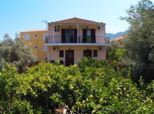 a house on top of a hill with trees at Zacharogianni Studios in Nikiana