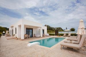 a villa with a swimming pool and patio furniture at Peratzada in Tsilivi