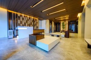 a lobby with tables and benches in a building at S Resort El Nido Managed by H Hospitality Group - Newly Renovated in El Nido