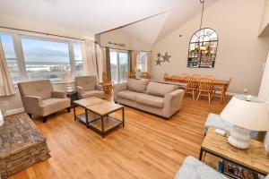 a living room with a couch and a table at OCEANFRONT, Priv Pool, Hot Tub -CP16, Sea You Soon in Corolla