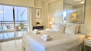 a bedroom with a large white bed with towels on it at STAY Charm Classic Apartment in Strovolos