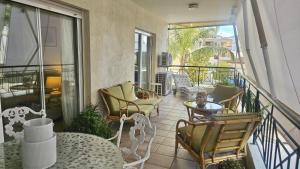 a balcony with chairs and tables on a balcony at STAY Charm Classic Apartment in Strovolos