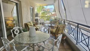 a balcony with tables and chairs on a balcony at STAY Charm Classic Apartment in Strovolos