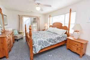 a bedroom with a bed and a dresser and a window at OCEANFRONT, Priv Pool, Hot Tub -CP16, Sea You Soon in Corolla +50 photos