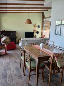 a dining room with a wooden table and chairs at La Casa de Alvear - Casco Histórico in San Antonio de Areco