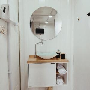 a bathroom with a sink and a mirror at Conteiner Beira Mar Solar Analuz Prox Beto Carrero in Navegantes +16 photos