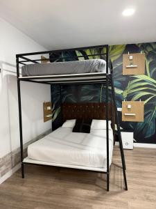a bedroom with a bunk bed with white sheets at Bouzasol in Vigo