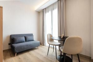 a living room with a couch and a table and chairs at Dobo Madrid Ricardos in Madrid +22 photos