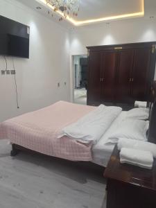 a bedroom with a large bed and a tv at Квартира в самом центре Душанбе in Dushanbe +2 photos