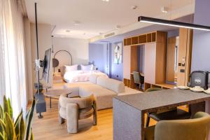 a hotel room with a bed and a living room at Si Hotel Tirana in Tirana