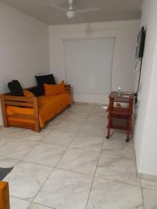 a living room with a couch and a table at Casita Rosa in San José
