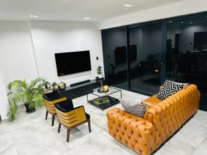 a living room with a couch and a table at Sucassa 54 - Luxury 2 Bedroom - Dam & Mountain View in Hartbeespoort