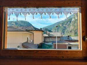 a window with a view of a mountain at La Lune de Saint George in Hone
