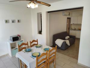 Una sala de estar con una mesa y sillas y un sofá. en Casa Maria by Holiday World, en Porto Garibaldi