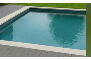 a swimming pool with blue water in a yard at Villa Nimfea in Ialyssos