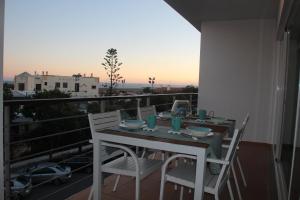 a table and chairs on a balcony with a view at Apartamentos Mar de Alvor in Alvor