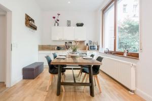 a kitchen and dining room with a wooden table and chairs at Excellent Apartment in the center of Berlin in Oberwolfach +52 photos