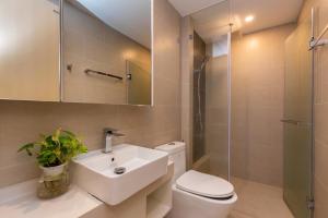 a bathroom with a sink and a toilet and a shower at The Sóng Apartment - Habi's Home in Vung Tau +62 photos