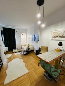 a living room with a table and a couch at Art Boutique Residence in Bucharest