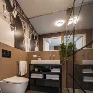 a bathroom with a toilet and a sink and a mirror at Central Tilburg Apartments in Tilburg