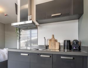 a kitchen with a sink and a counter top at Central Tilburg Apartments in Tilburg