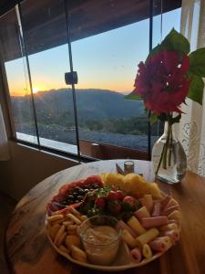 a plate of food on a table with a plate of food at Chalés Ser Tão di Minas in Paraisópolis +38 photos