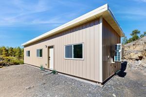 a smallshed with a building on a gravel lot at Trails & Tranquility in Pagosa Springs