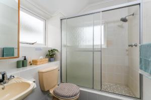 a bathroom with a shower and a toilet and a sink at Spectacular views Simonstown in Cape Town +49 photos