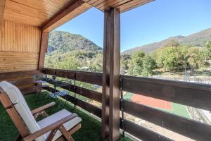 a room with a balcony with a view of a mountain at L'Ostalet suite luxe Jacuzzi in Ax-les-Thermes