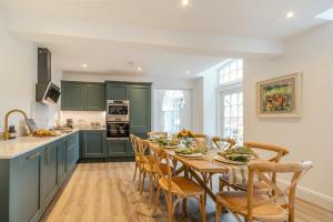 a kitchen with green cabinets and a table with chairs at 3 Bed in Upper Sapey oc-s33623 in Upper Sapey