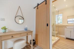 a bathroom with a wooden desk and a mirror at 3 Bed in Upper Sapey oc-s33623 in Upper Sapey +25 photos