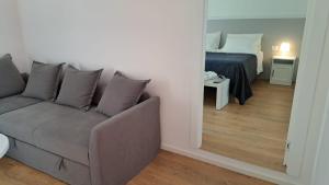 a living room with a couch and a bed at Antica Dimora Petito Luxury Suites in Matera