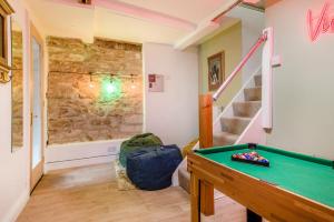 a room with a pool table and a stone wall at 3 Bed in Wotton-under-Edge oc-l33488 in Wotton under Edge