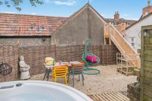 a backyard with a table and chairs and a fence at 3 Bed in Wotton-under-Edge oc-l33488 in Wotton under Edge